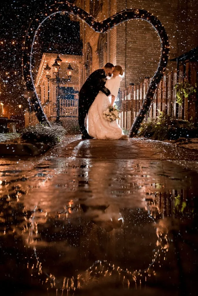 wedding couple kisses in the snow at puddicombe house