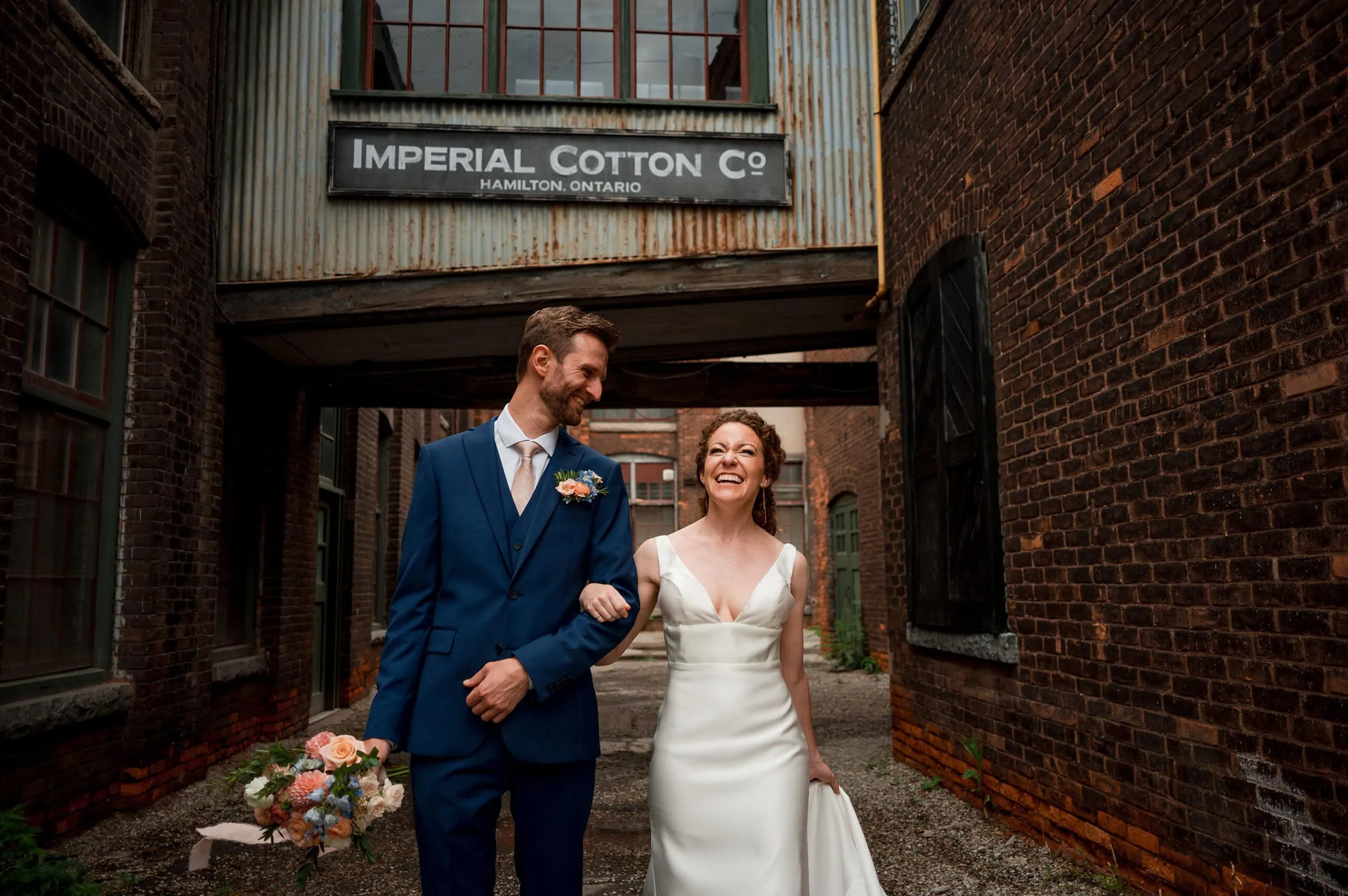 bride & groom walking through historic industrial complex formerly known as The Imperial Cotton Company in Hamilton Ontario